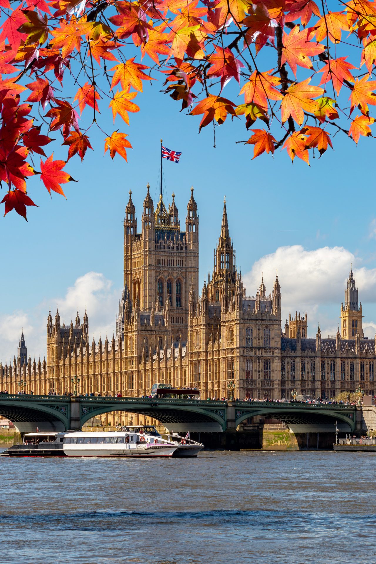 Big Ben tower of Houses of Parliament in autumn, London, UK