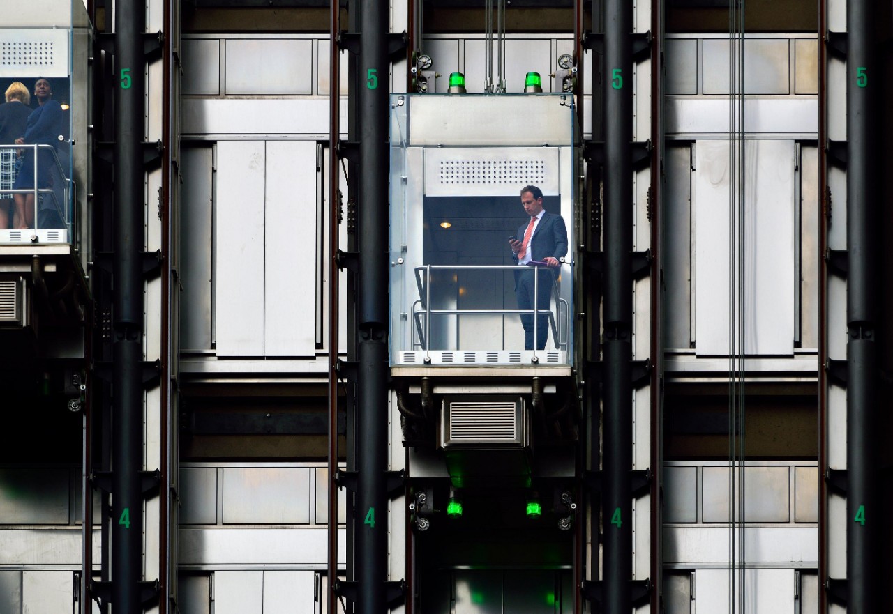 GXKGP4 London, England, UK. Glass lifts in Lloyd's Insurance building in the City.